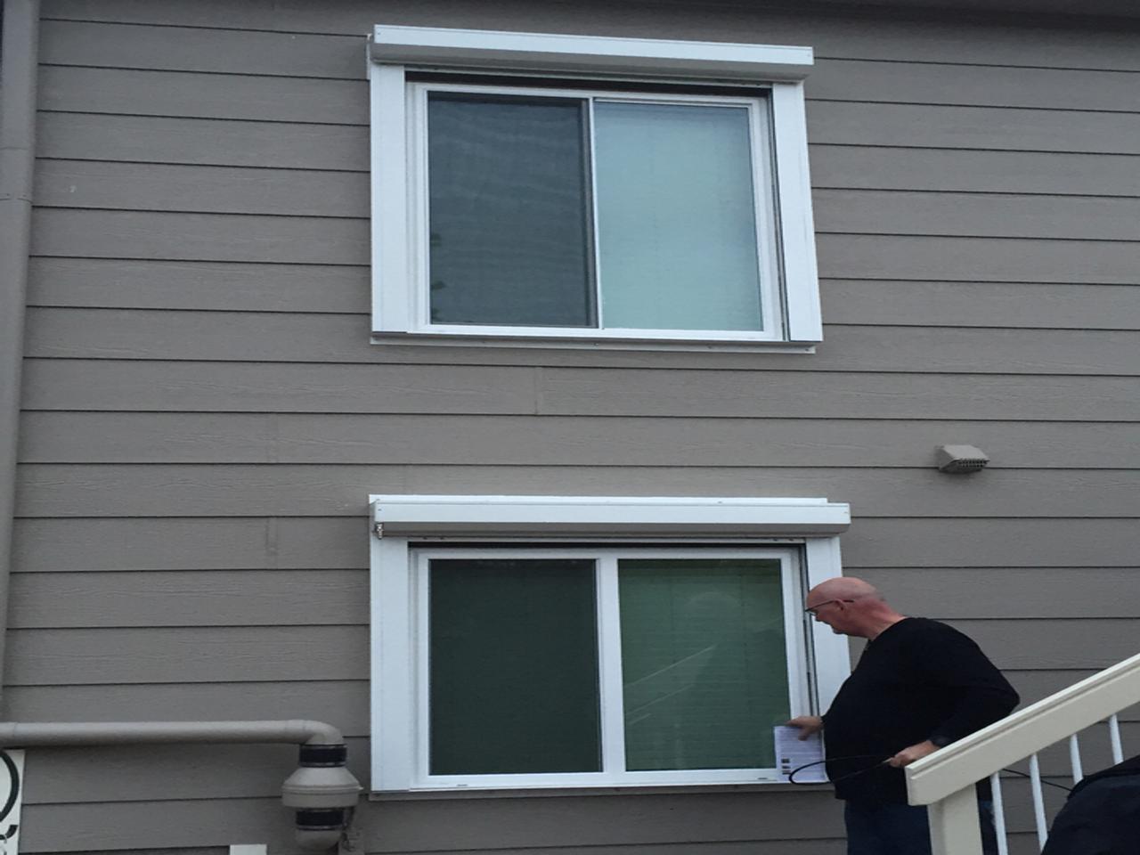 Installing hurricane shutters on a house