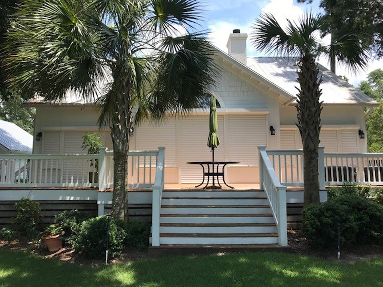 Back of home with hurricane shutters lowered