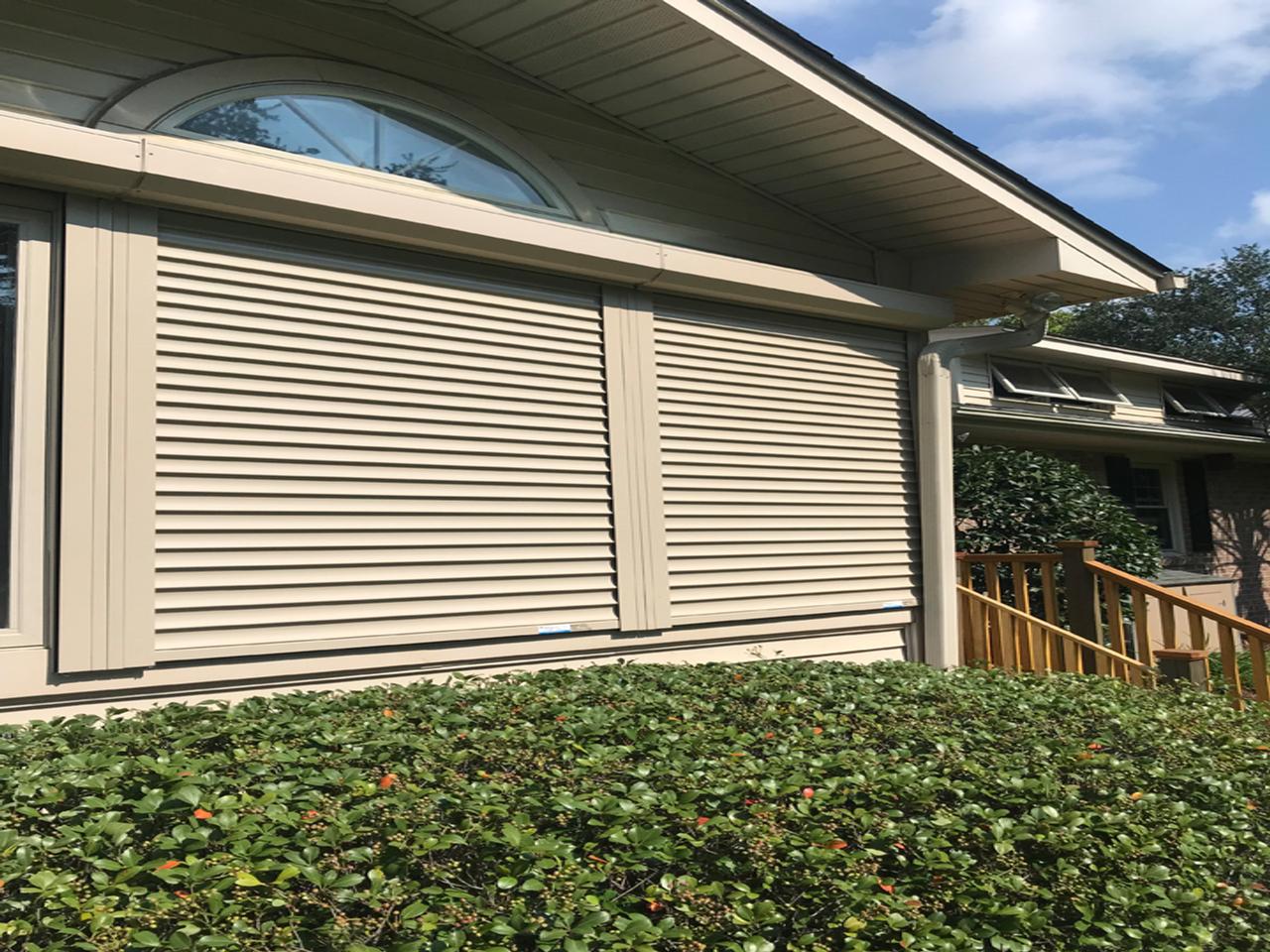 Lowered hurricane shutters on a home