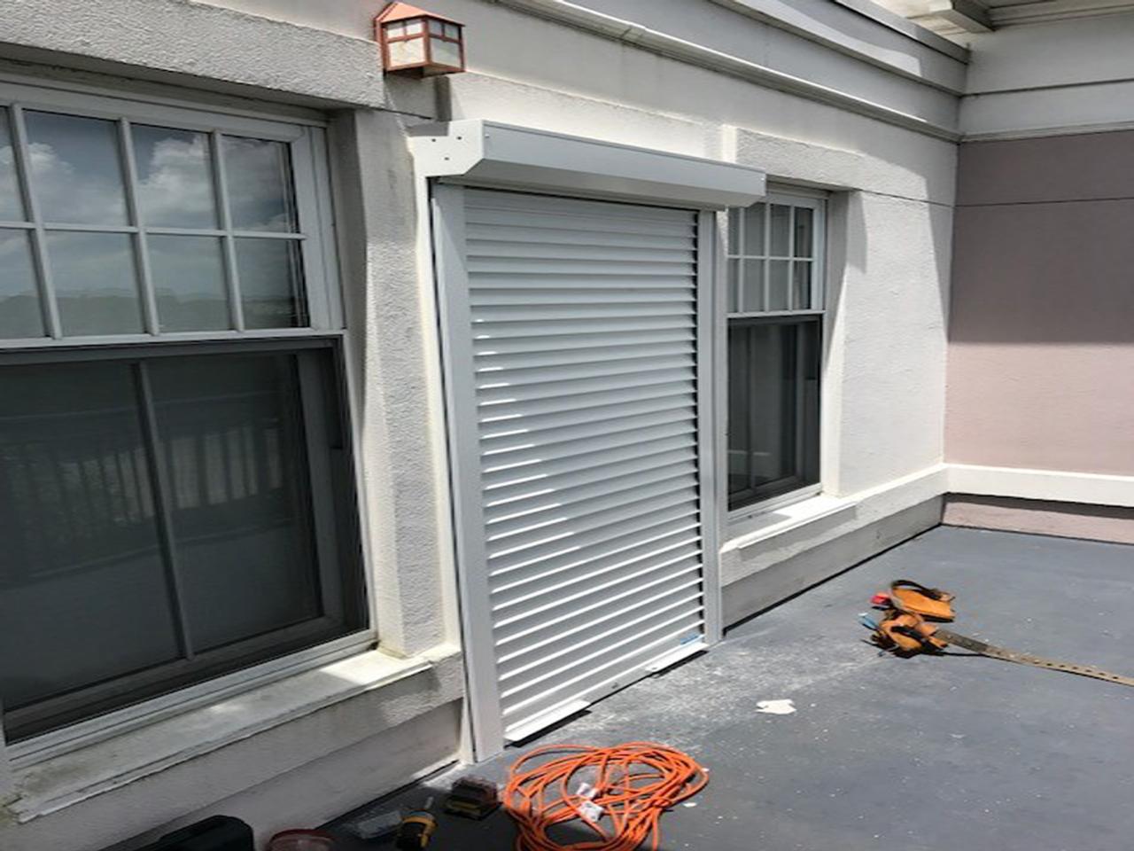 Sliding glass door with hurricane shutters