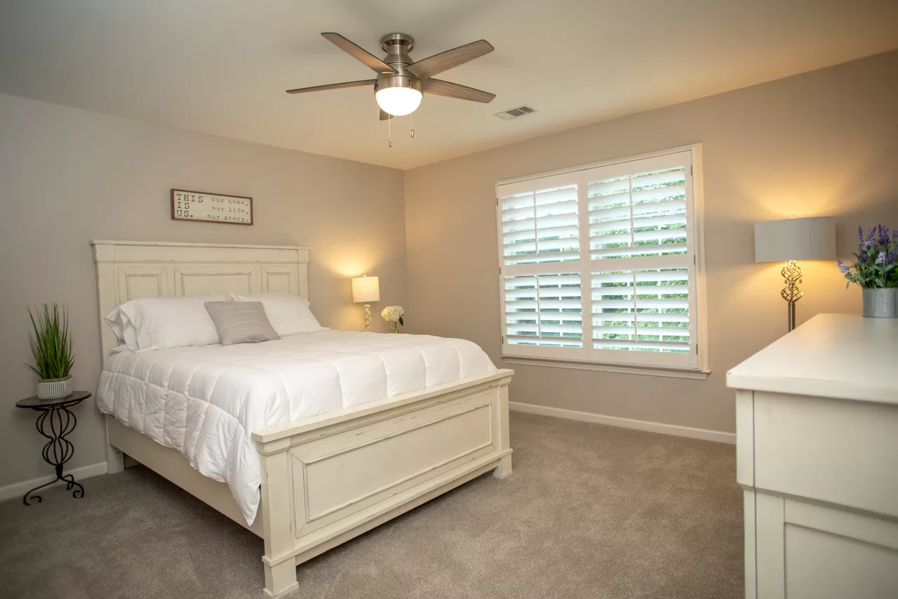 Heritage wood plantation shutters in a bedroom