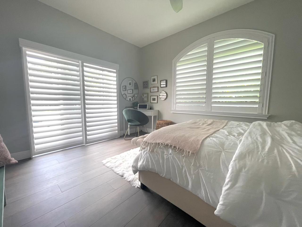 Bedroom with sliding glass door with shutters