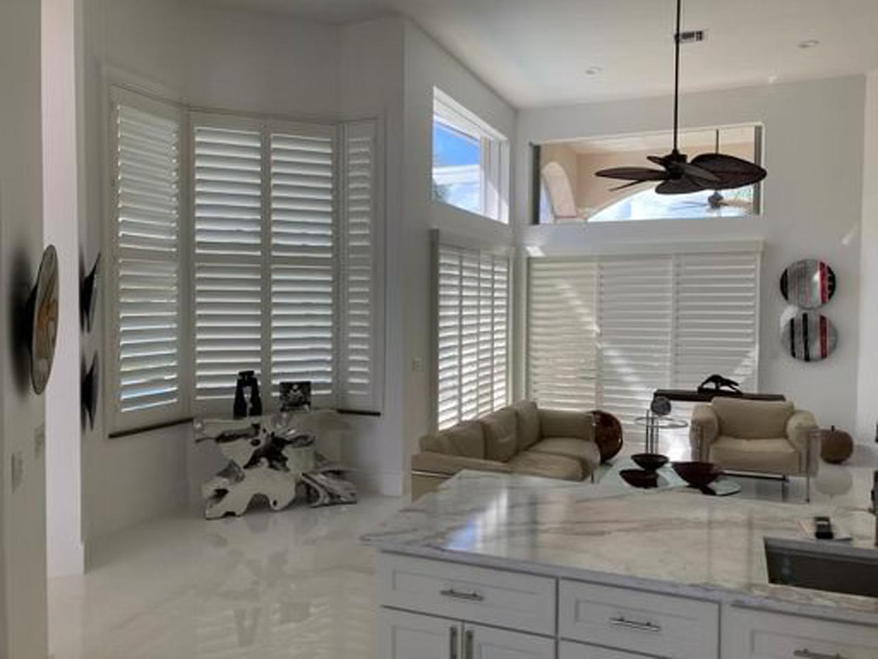 Open concept kitchen and living room with interior shutters