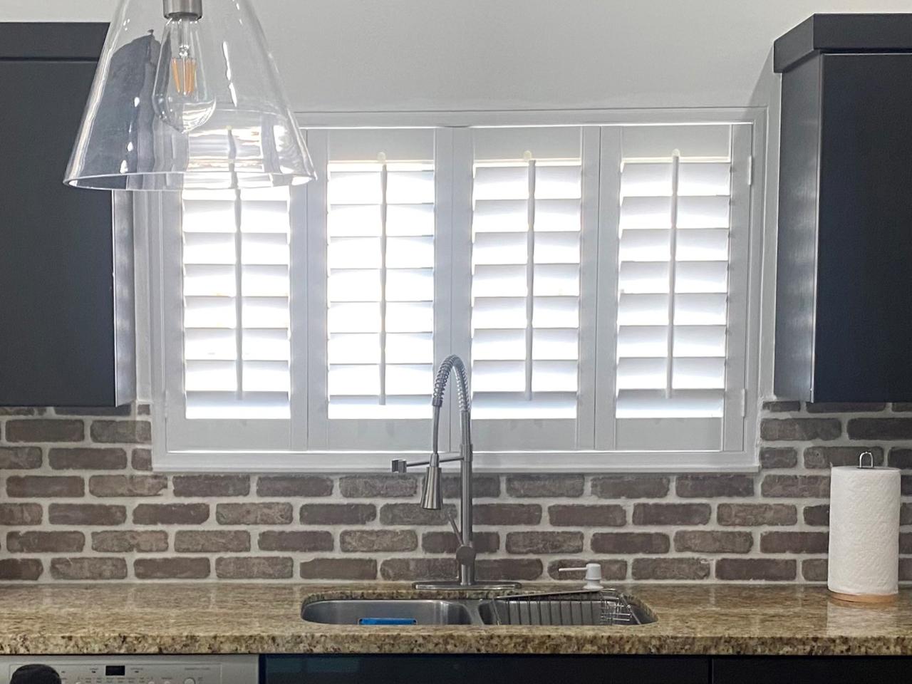 Plantation shutters over kitchen sink