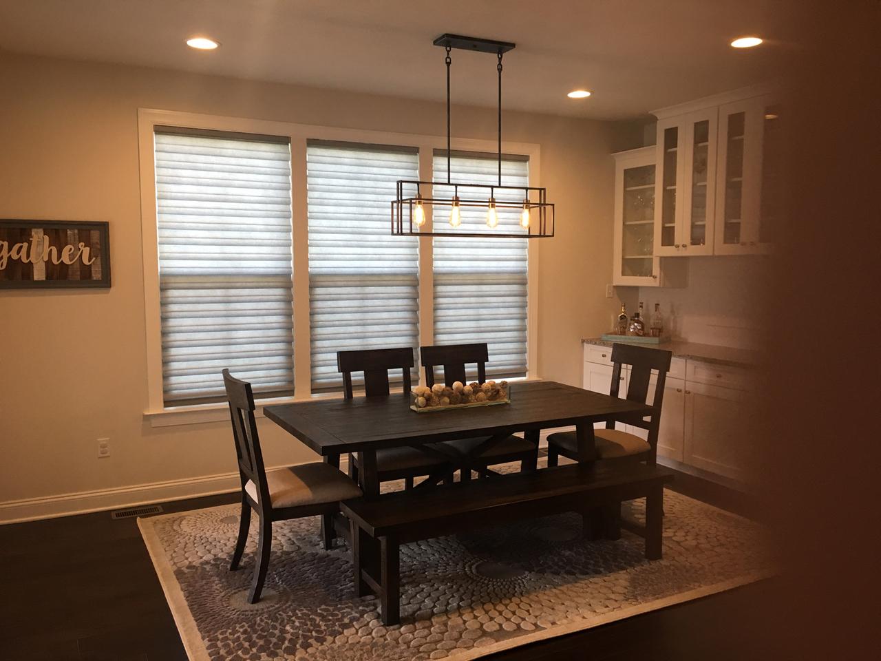 Modern Roman shades in a dining area