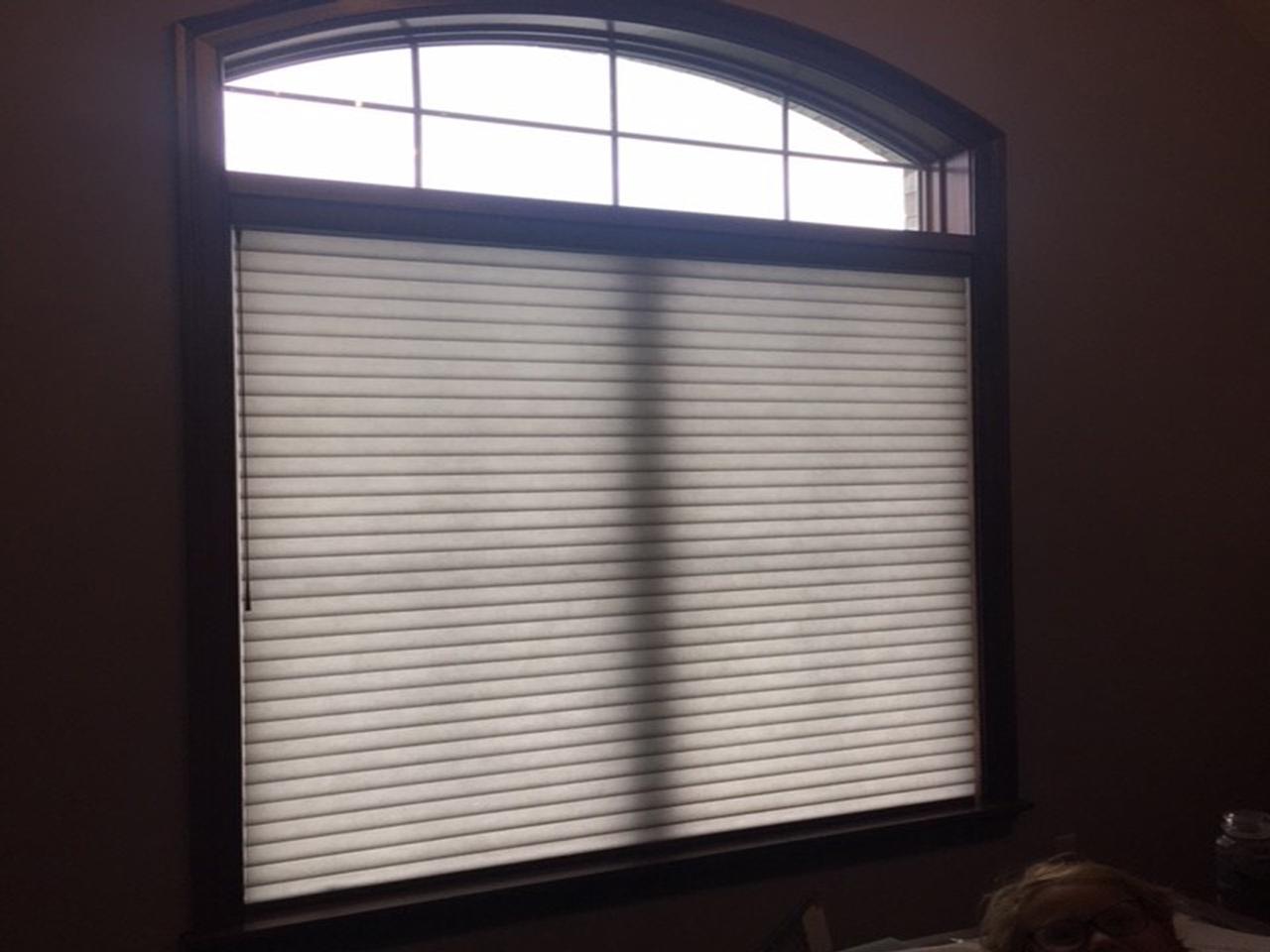 Honeycomb shades on arched window