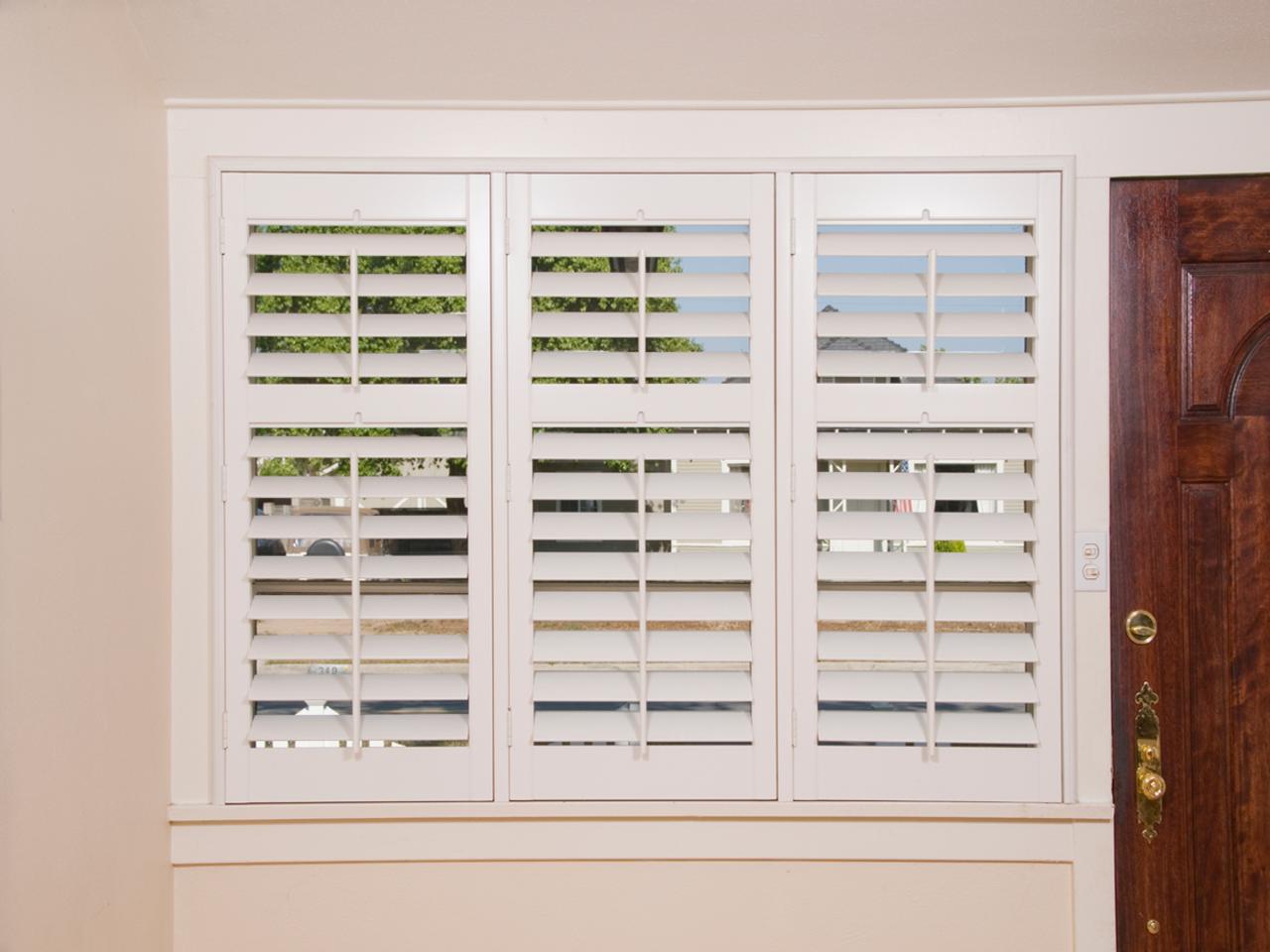 Interior shutters on windows by front door