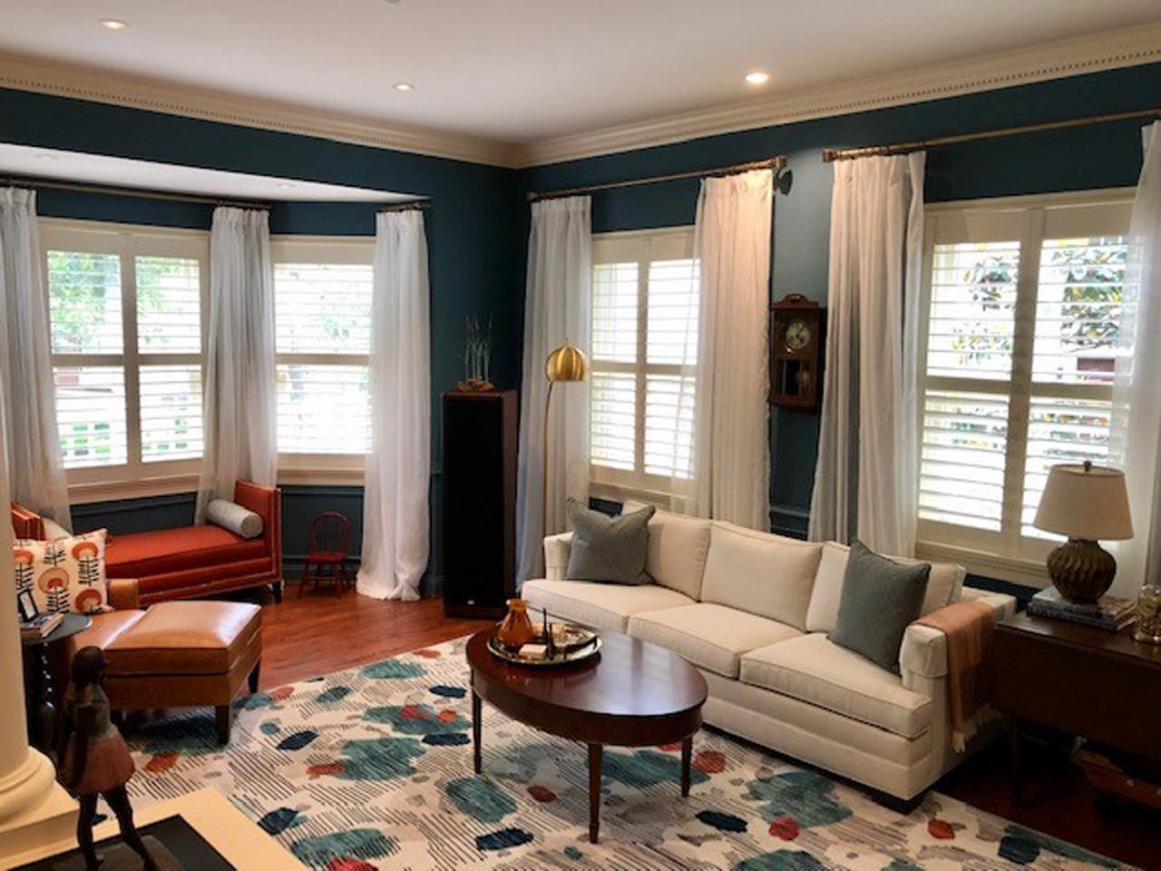 Shutters and drapes in living room