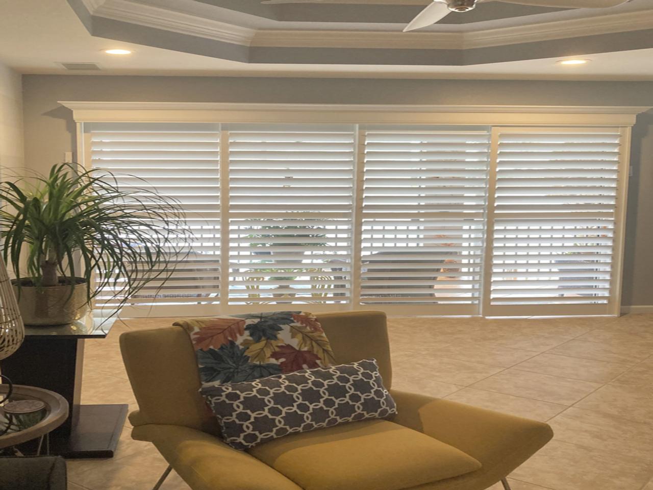 Living room with sliding glass doors with shutters