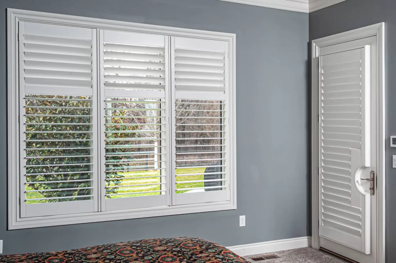 wood shutters on bedroom windows and doors