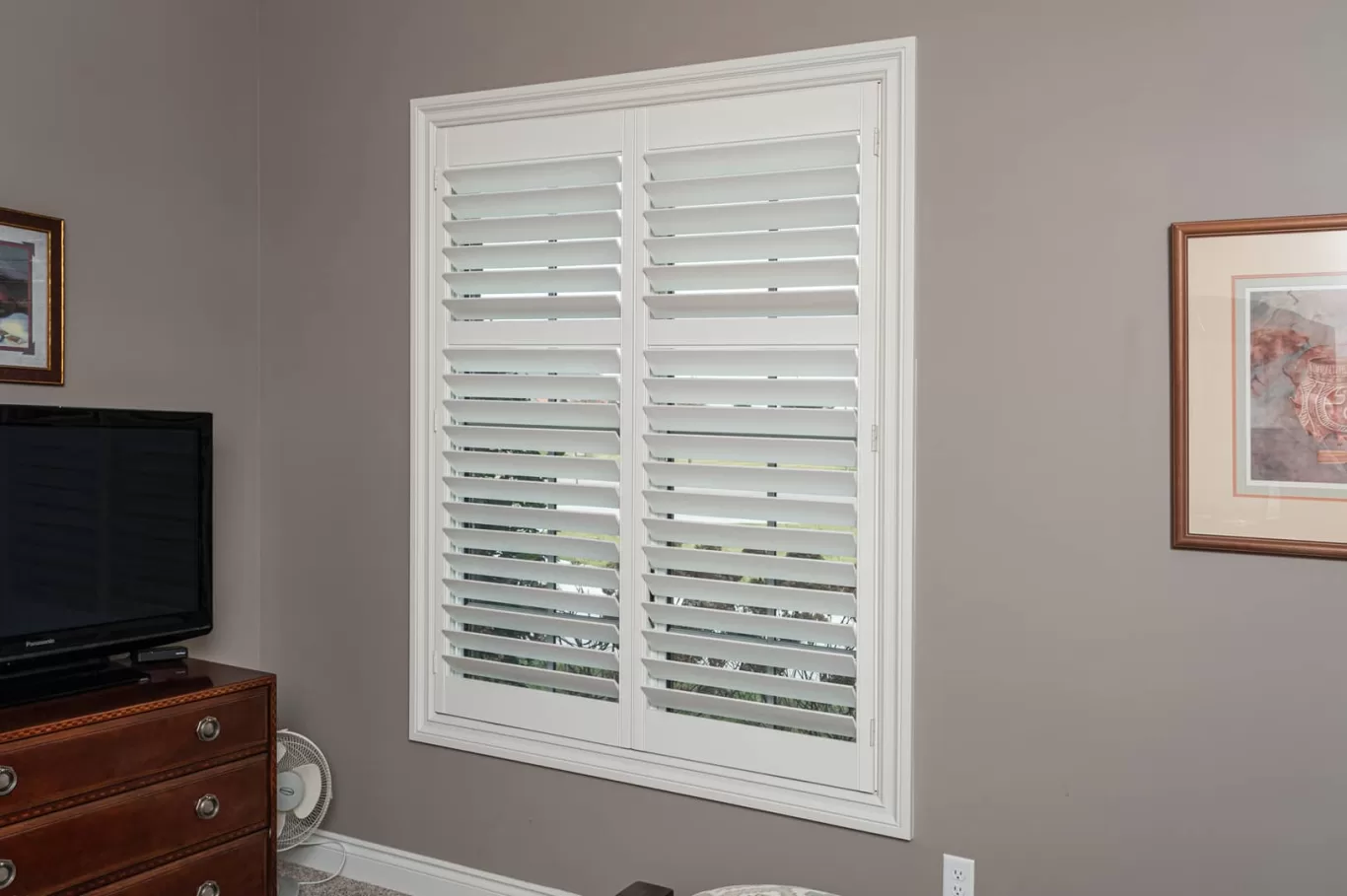 Louver Shop Heritage Wood Shutters installation in a bedroom