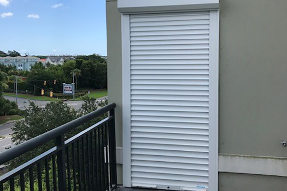 Board and batten shutters on stone and brick house