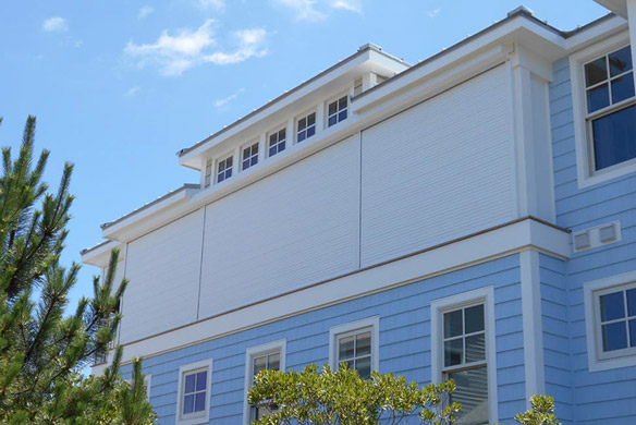 Board and batten shutters on stone and brick house