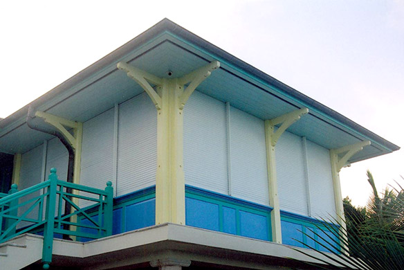 Board and batten shutters on stone and brick house