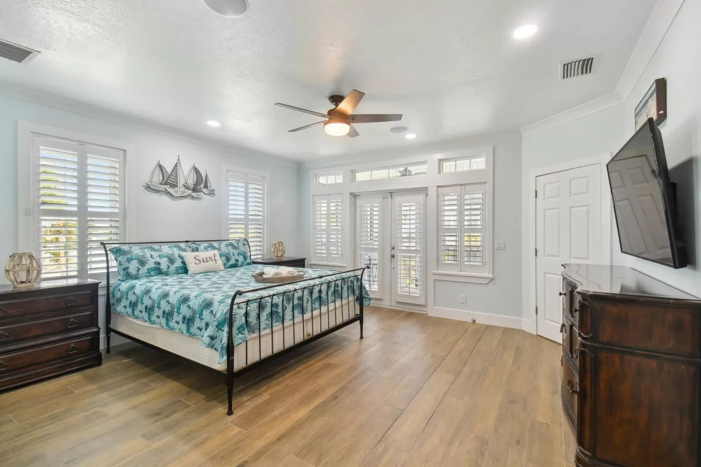 LouverWood Shutters on windows and French doors - Bedroom