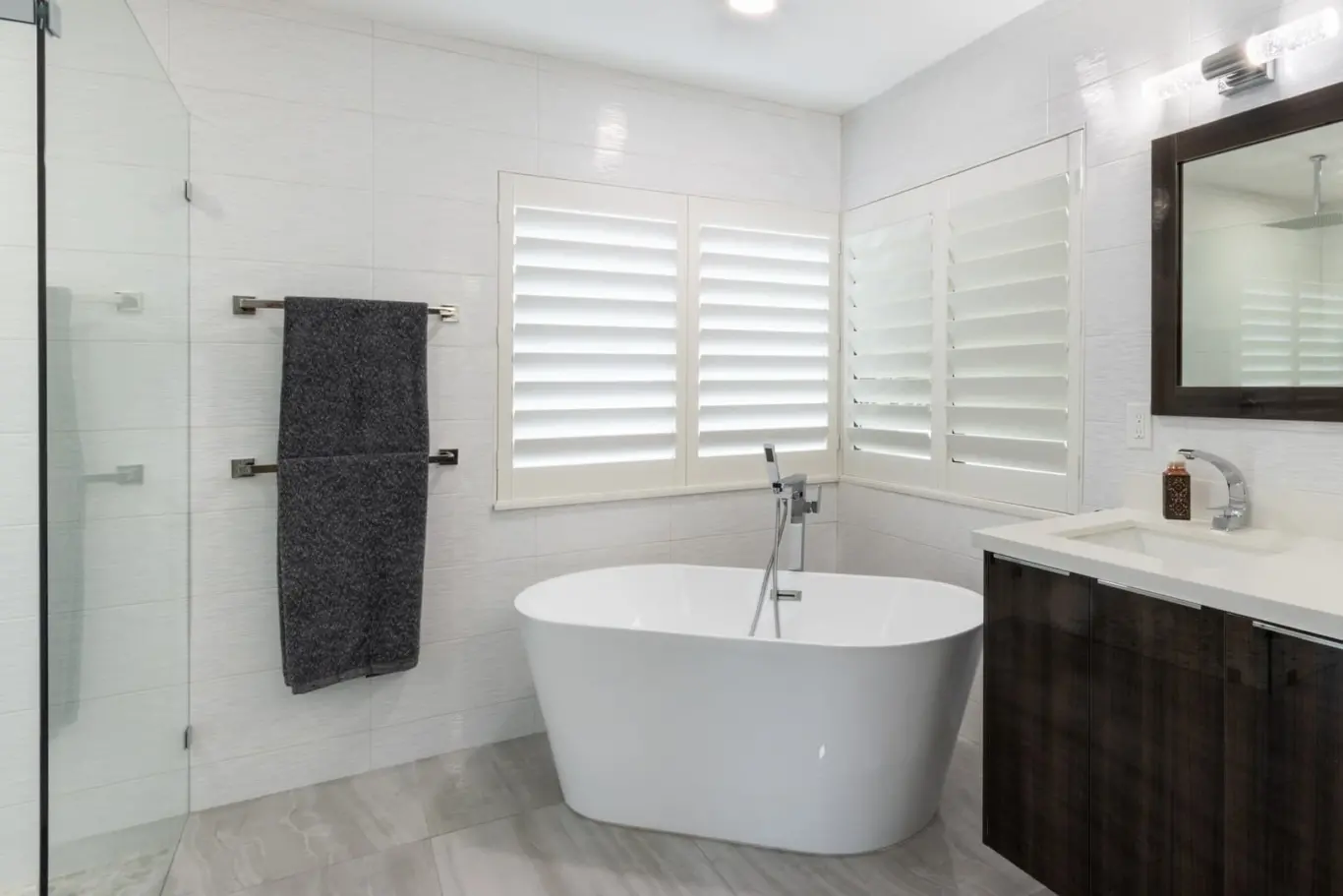 LouverWood plantation shutters above a luxury bathtub