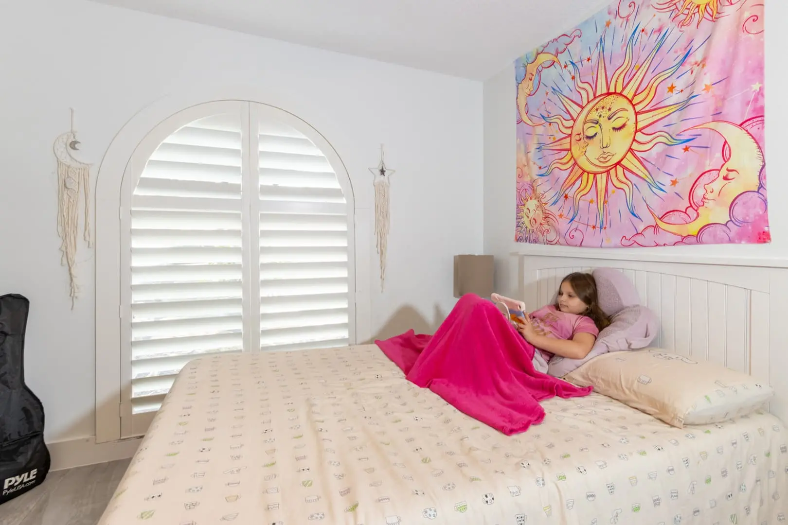 girl's bedroom with Heritage Plantation Shutters on an arched window