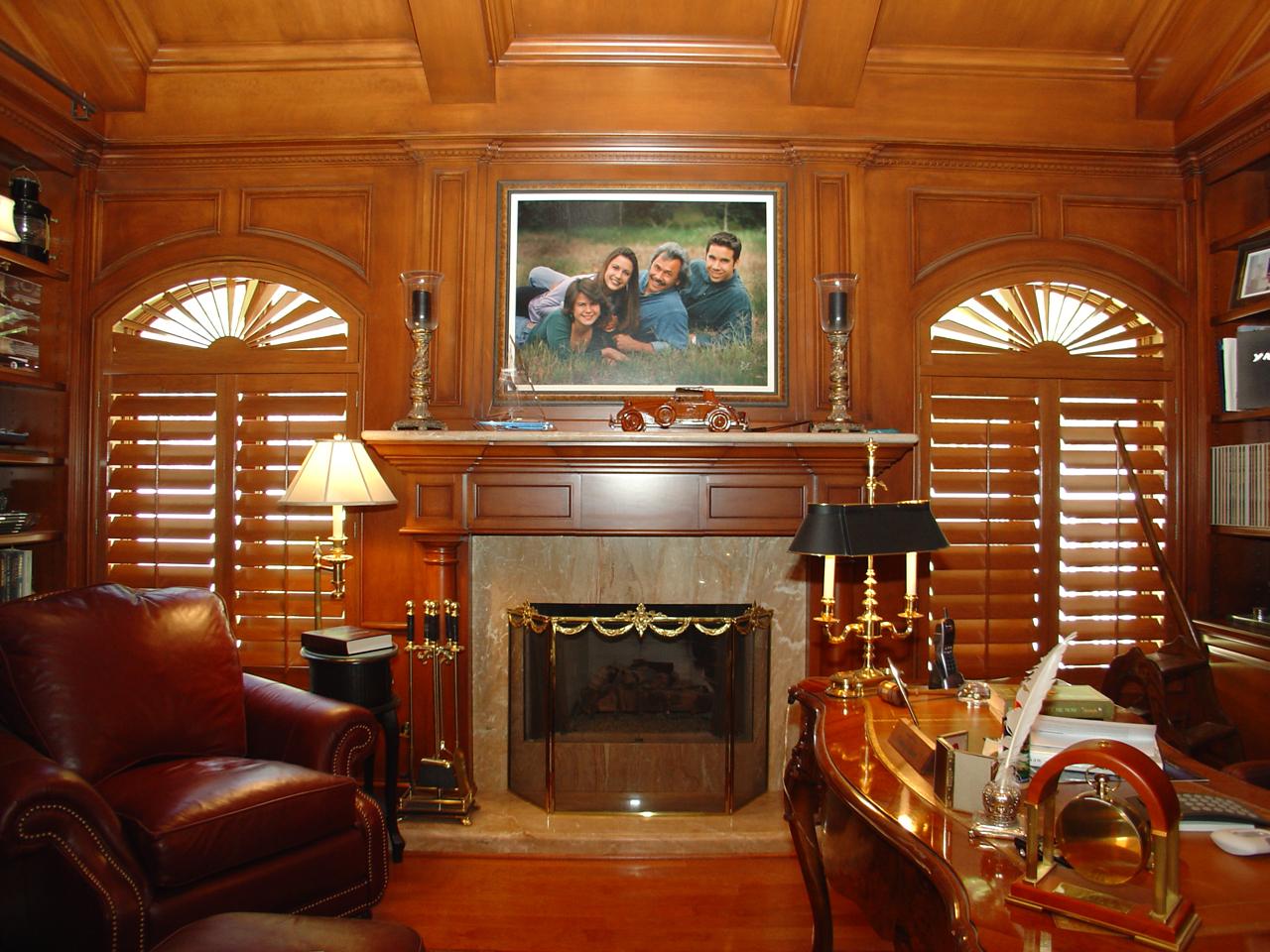 Home office with stained arched shutters with sunburst