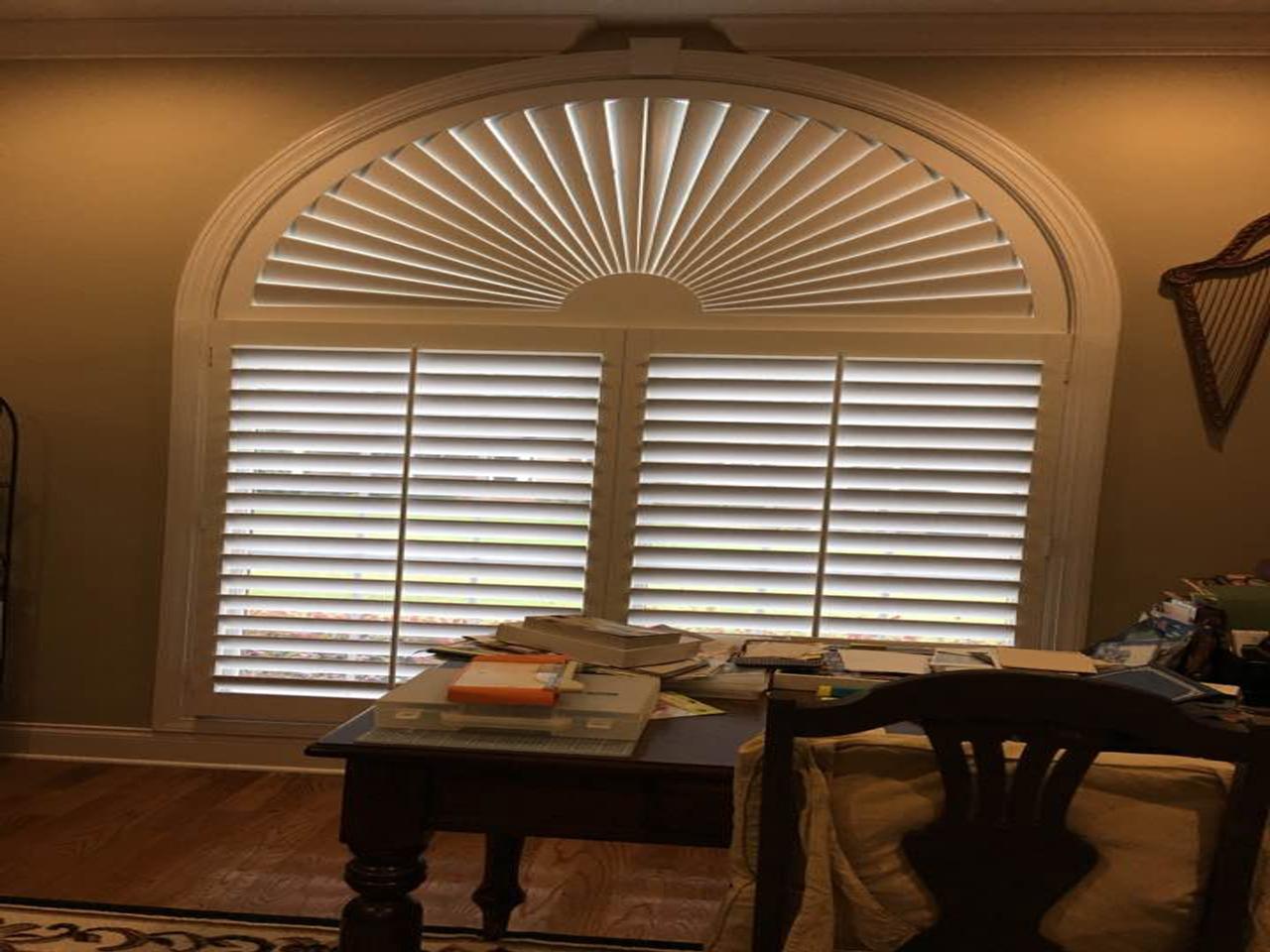 Home office with sunburst on the arch top of the window