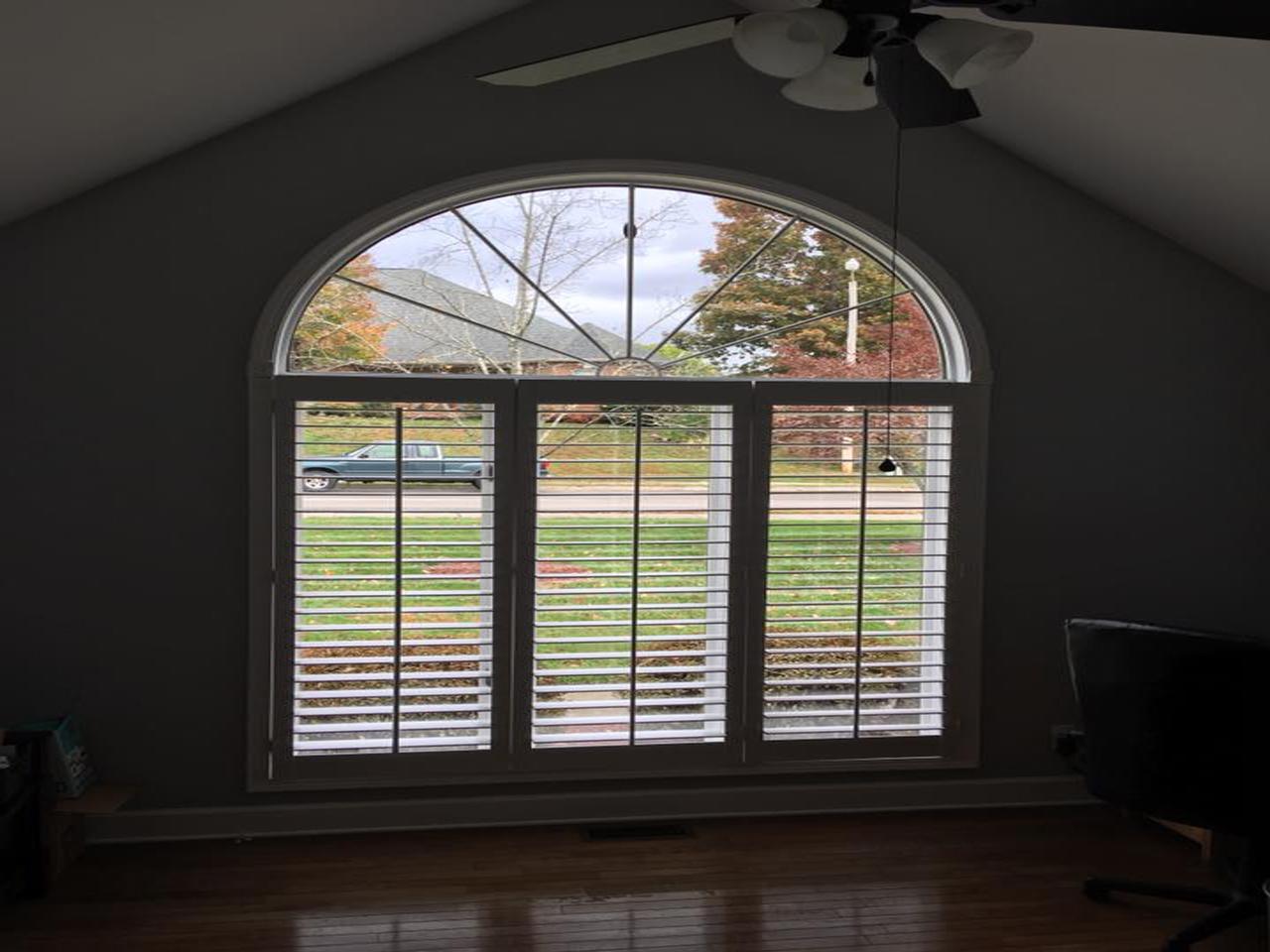 Classic shutters on arched window with open arch