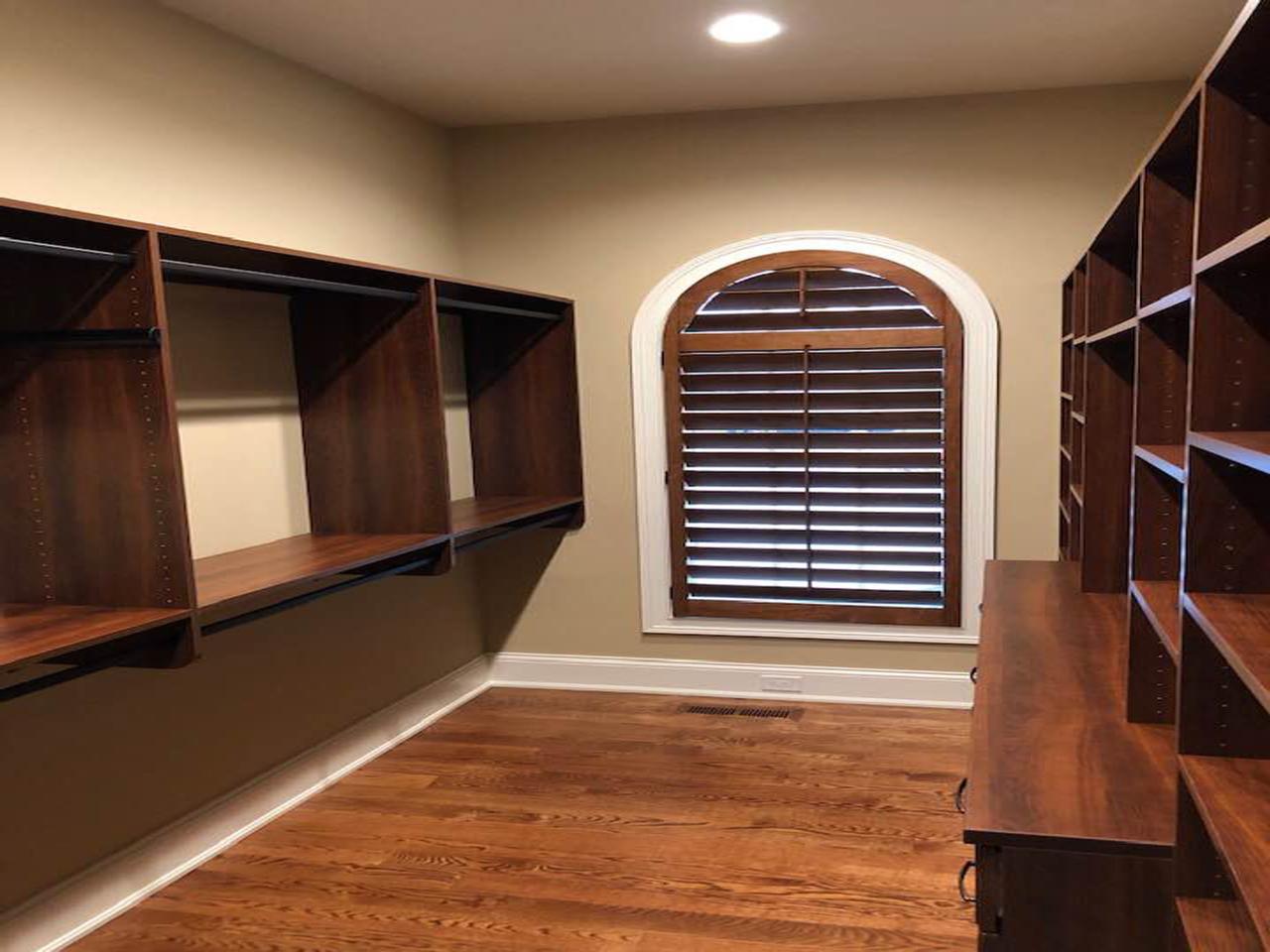 wood shutters on an arched closet window