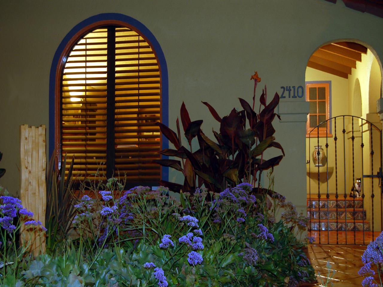 Outside view of stained shutters on an arched window