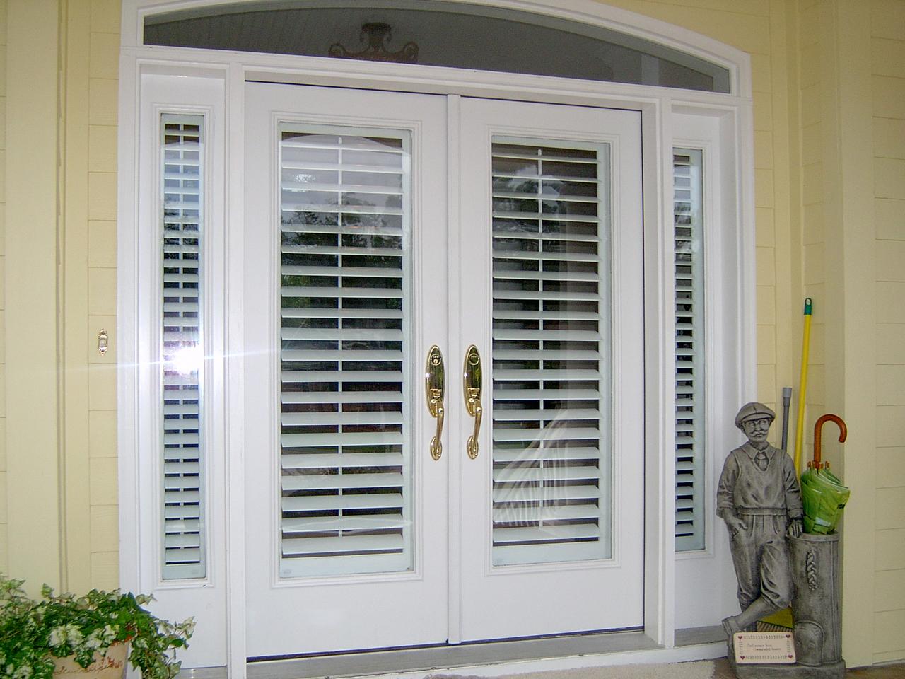 Exterior View of front door and sidelights with plantation shutters