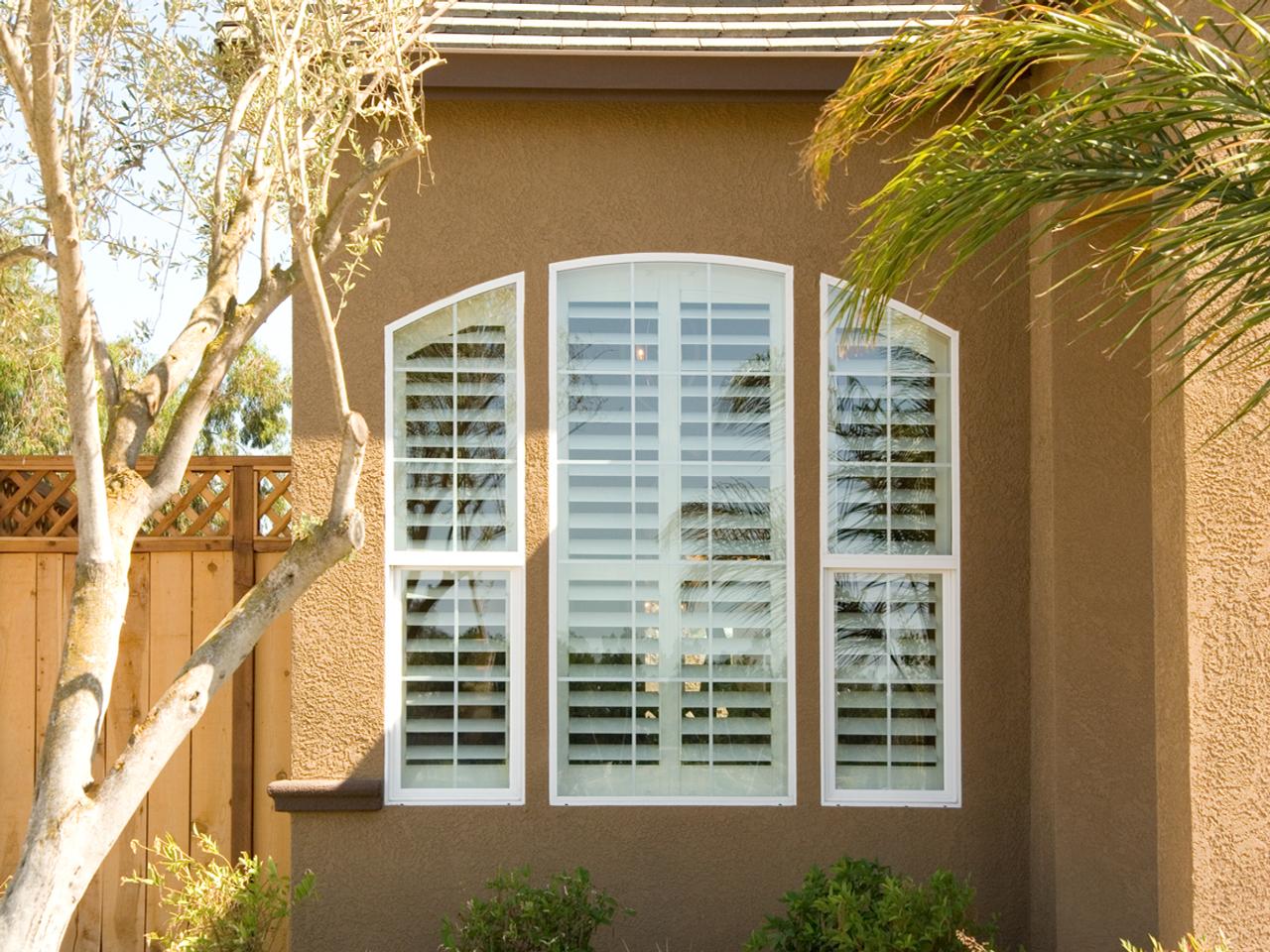 Exterior view of shutters on set of arched windows