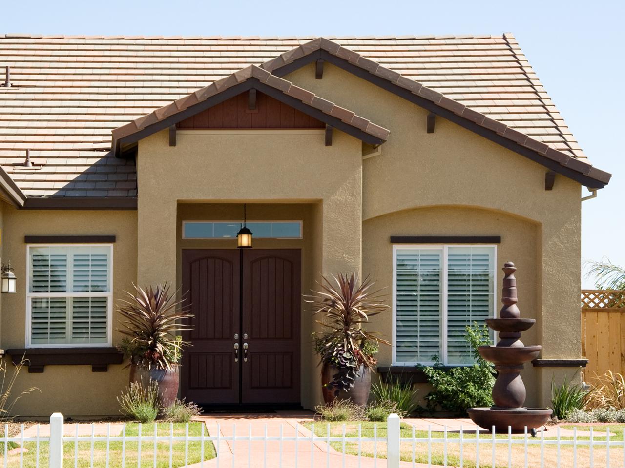 Outside view of mediterranean home with plantation shutters