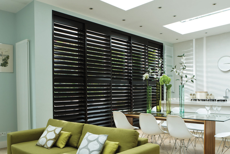 Black Plant Shutters In Dining Room