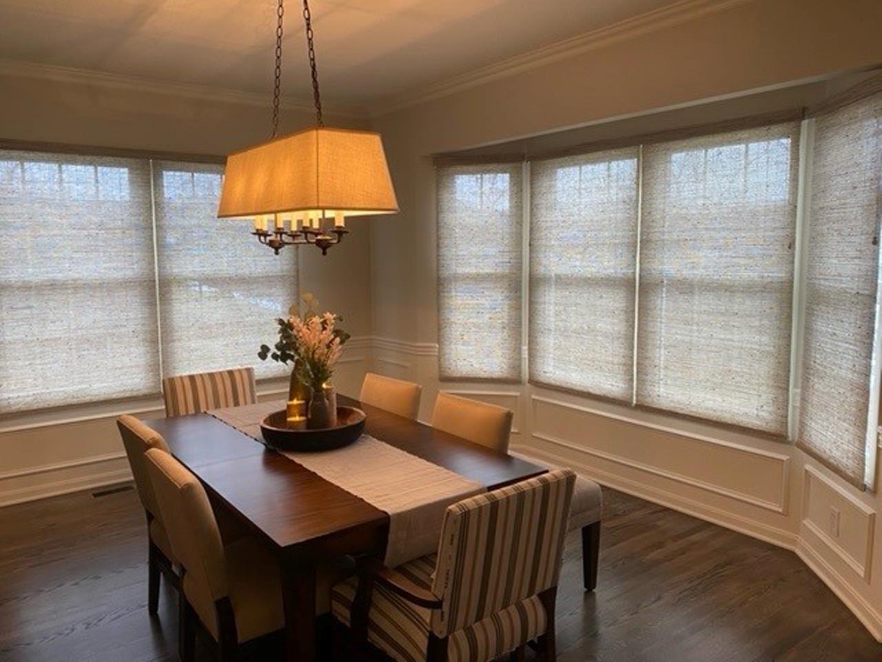 Designer screen shades in dining room