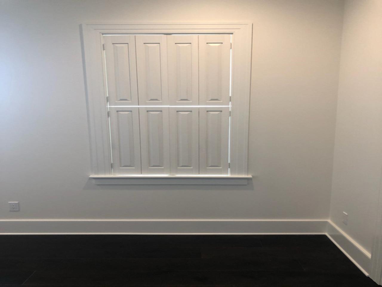 Raised panel shutters on a window