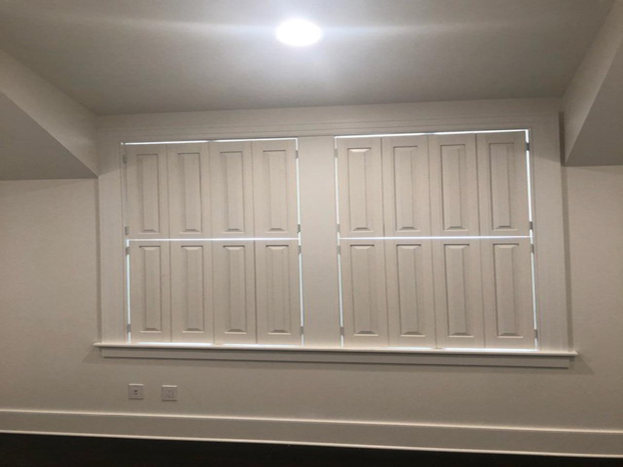 Raised panel shutters on a window
