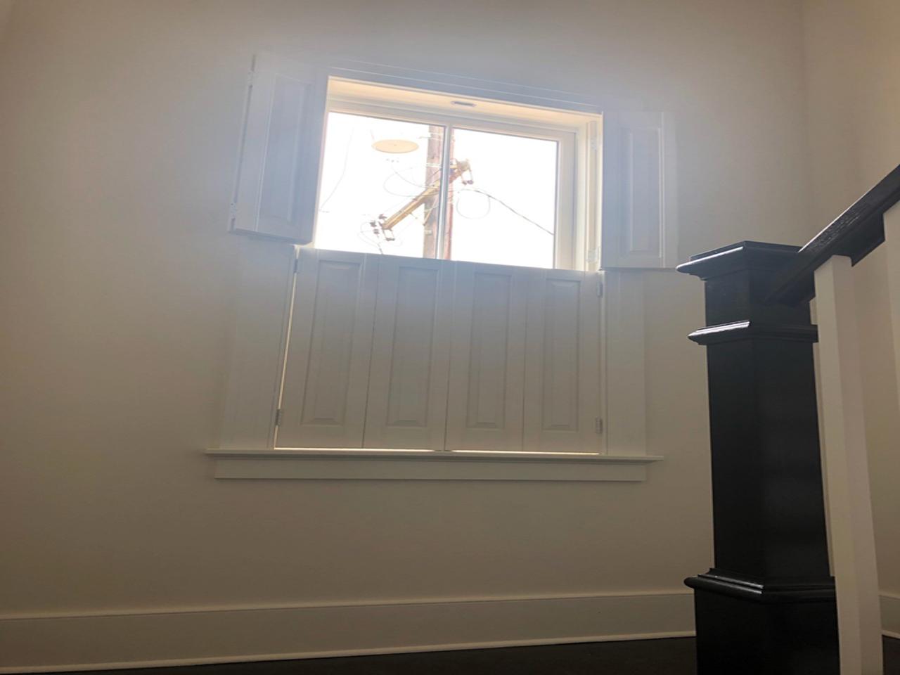 Raised panel shutters on a stairway