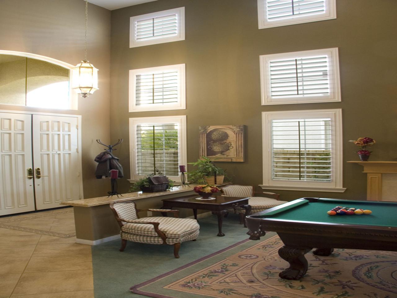 Plantation shutters in a rec room with dark tilt rod