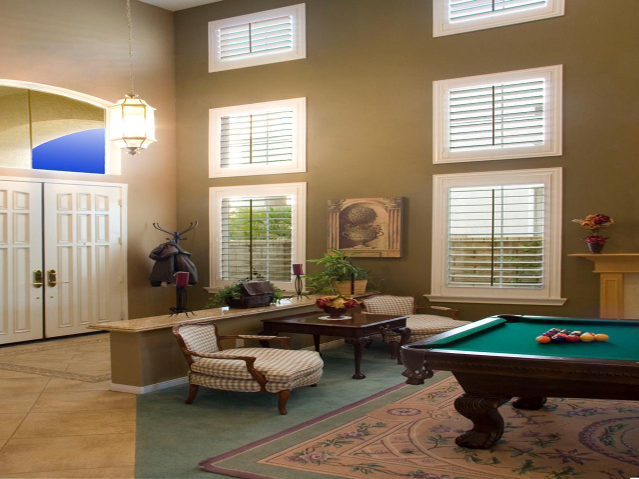 Rec room with plantation shutters with dark tilt rod