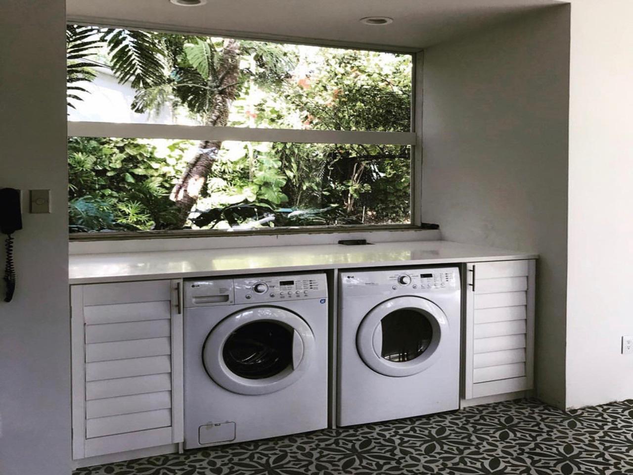 shutter doors next to a washer and dryer