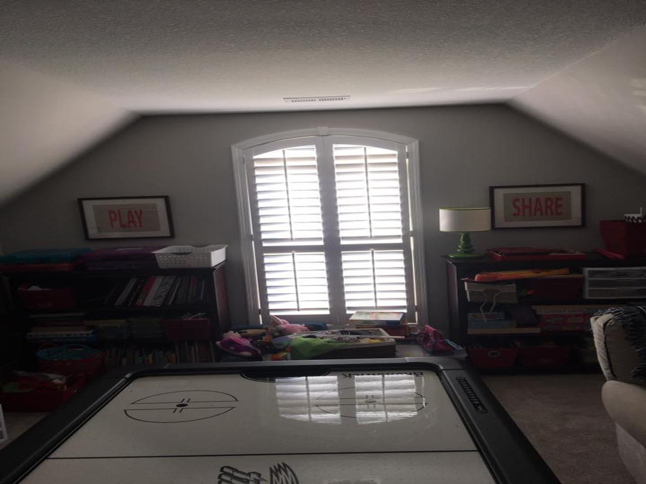 Interior shutters on window in a rec room