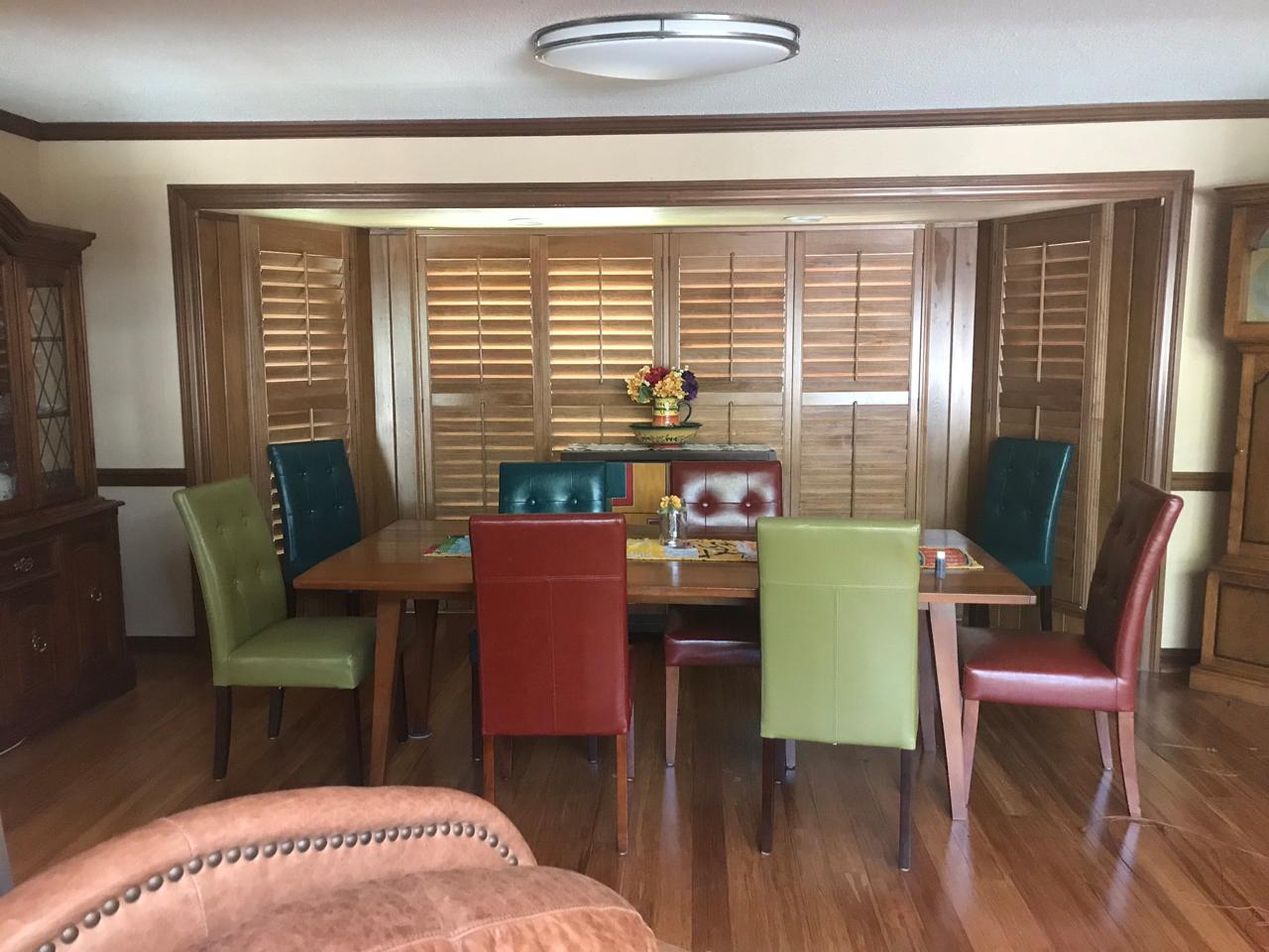 Dining room with stained shutters on the bay window