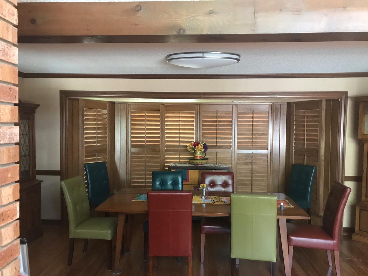 Dining room with stained shutters on the bay windows