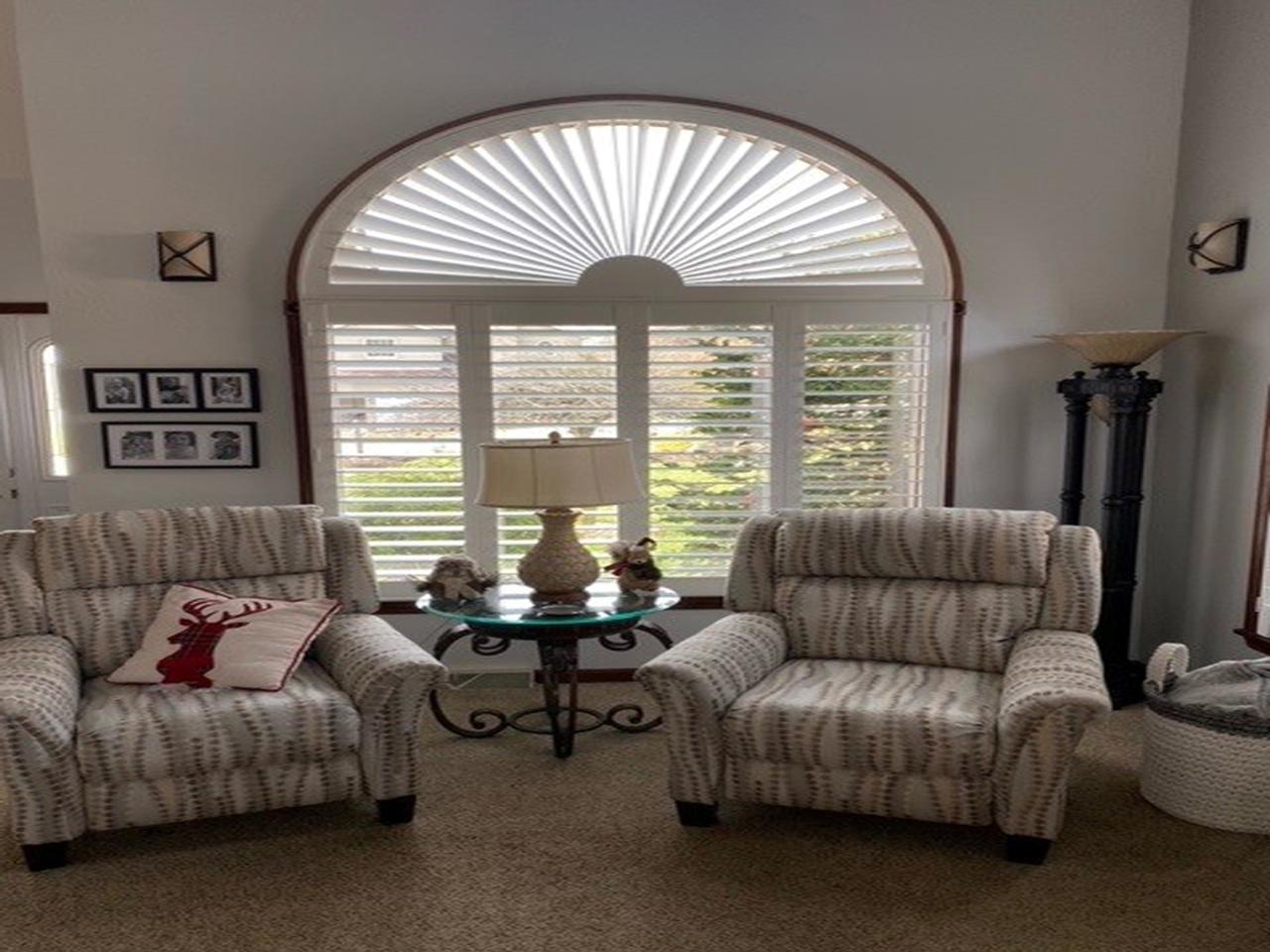 Arched window with sunburst and shutters