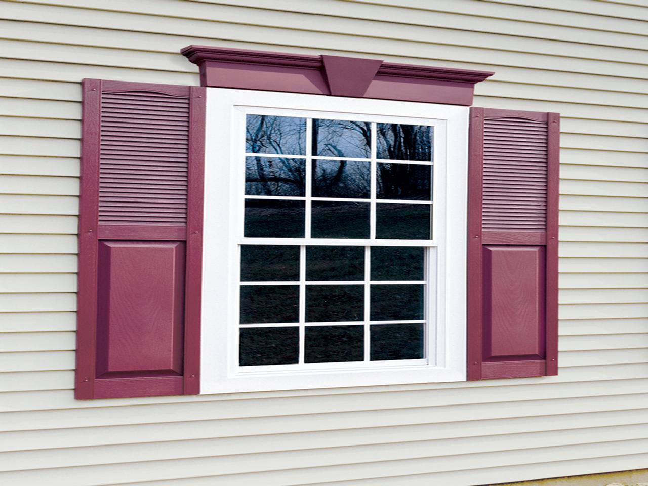 Louvered and solid shutter combination on a house