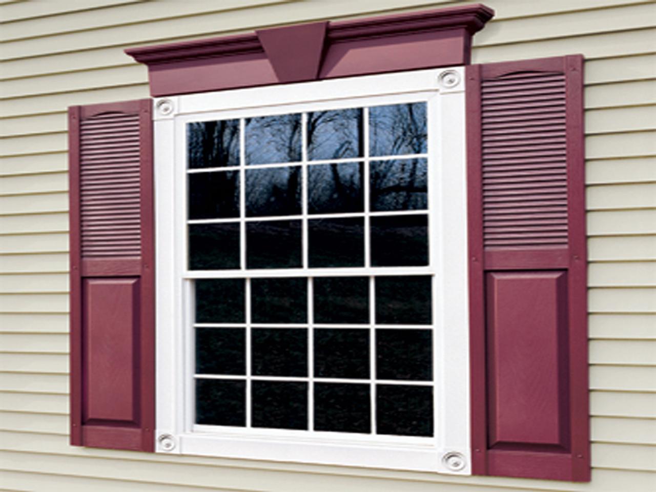 Wine colored combination shutters with louvered tops and solid bottom
