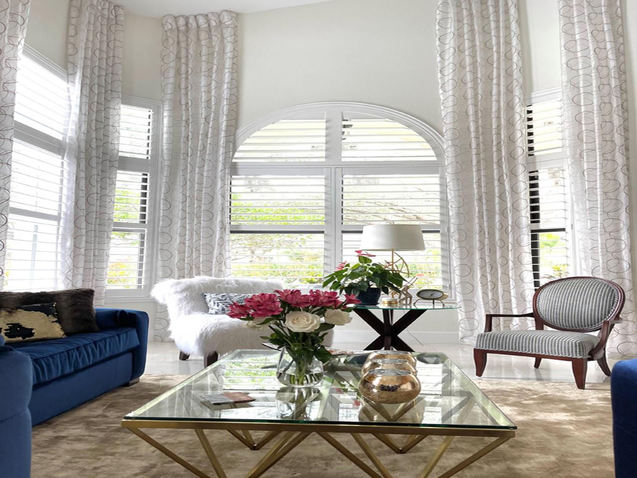 Arched windows with shutters in a living room