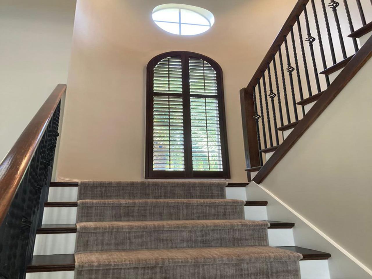 Stained arched shutters on stairway
