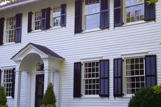 louvered storm shutters on a home