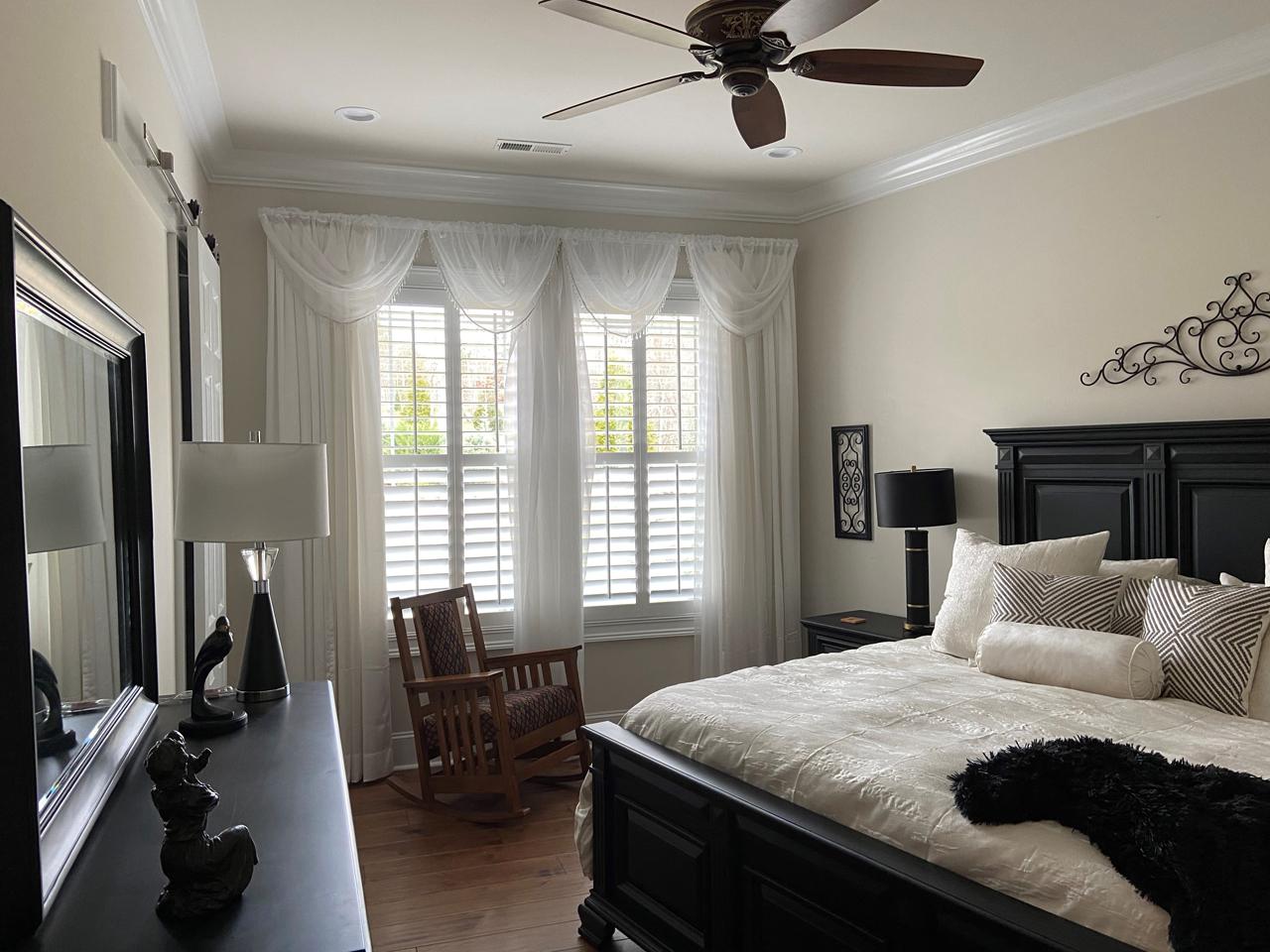 Bedroom with shutters and drapes