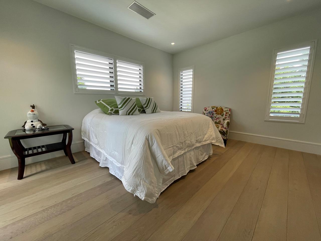 Bedroom with poly shutters