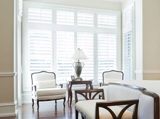 interior shutters in a guest bedroom