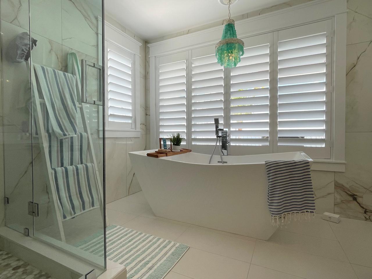 Shutters over modern bathtub